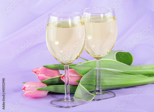 White wine and pink tulip flowers