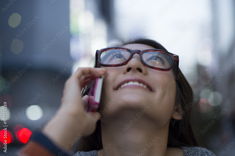 Young women are the phone while looking up at the sky Young women are the phone while looking up at the sky