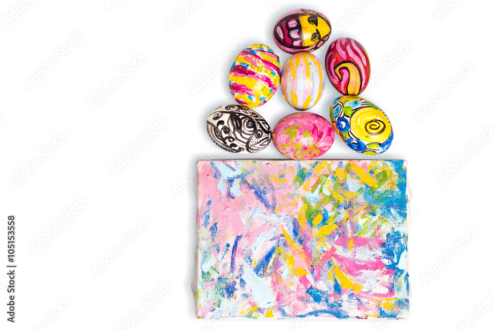 Colorful easter egg and small painted canvas on white