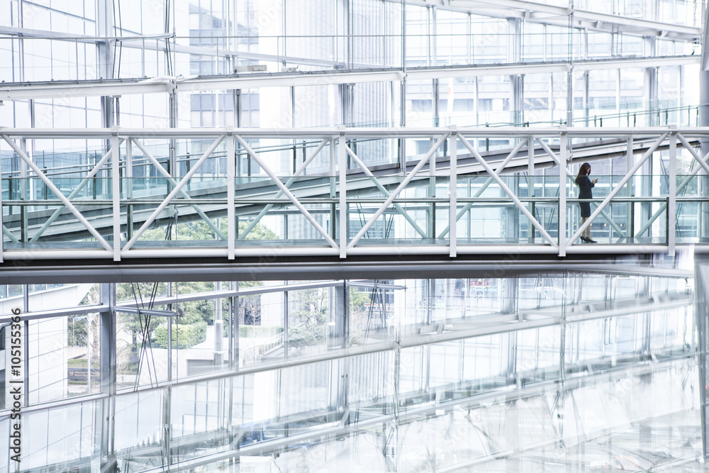Woman looking at the smartphone in a modern building Woman looking at the smartphone in a modern building