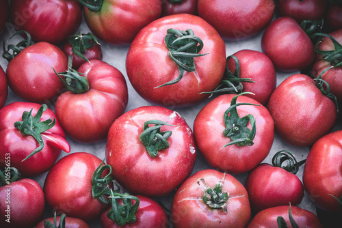 Heirloom tomatoes in display at a market. Organic  heirloom tomatoes  juicy and nutricious for sale at market