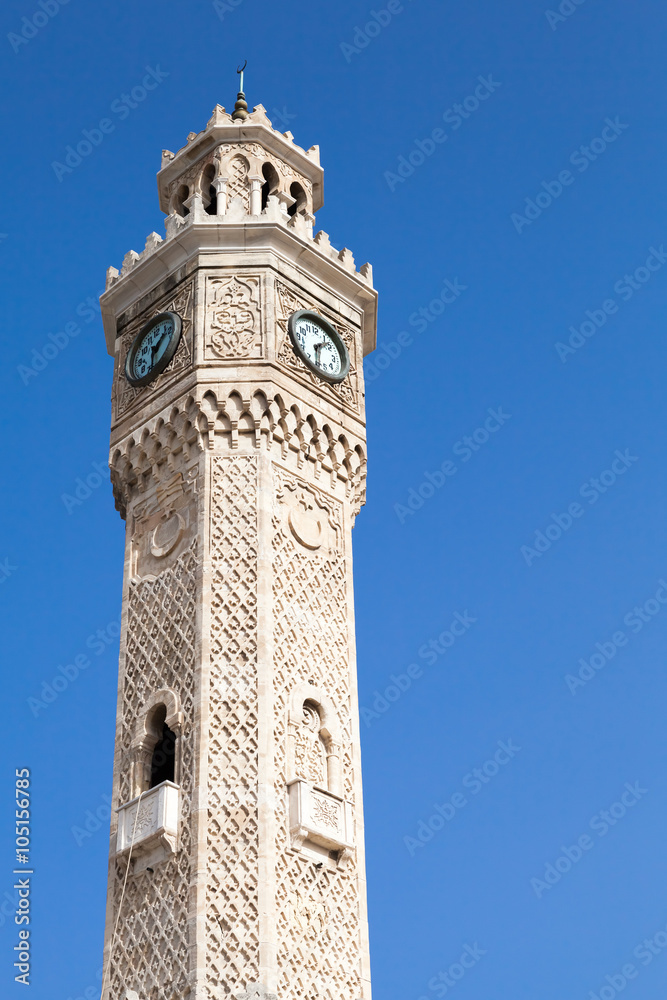 Izmir, historical clock tower over bright blue sky