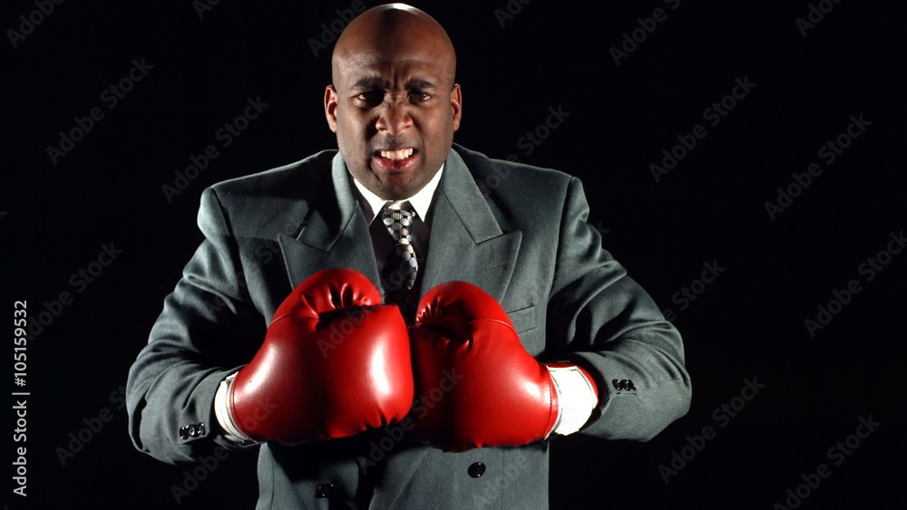 Busiessman with boxing gloves, slow motion Busiessman with boxing gloves, slow motion