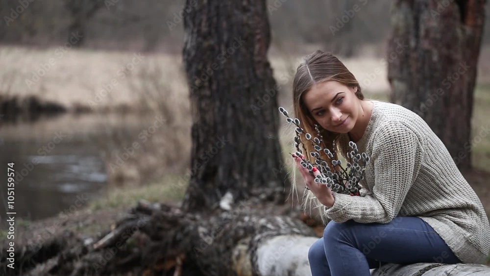 The girl in the early spring, the water sits on the river bank The girl in the early spring, the water sits on the river bank