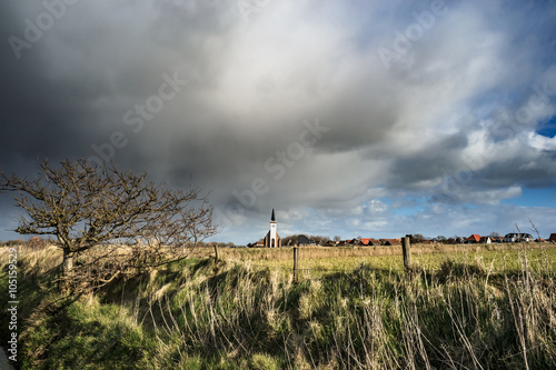Typical white church in landscape at the island  Texel  Holland