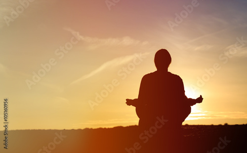 man doing yoga at sunset sky © nadezhda1906