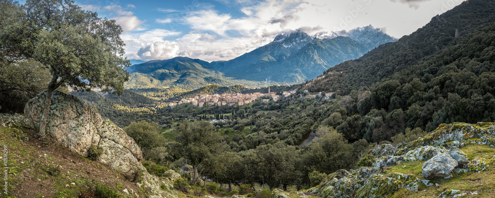 Village of Moltifao in Corsica with snow covered mountains behin