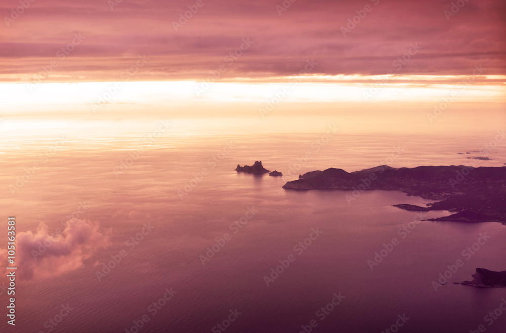 View over the south west of Ibiza Island with the magic rock of es Vedra in sunset. View over the south west of Ibiza Island with the magic rock of es Vedra in sunset.