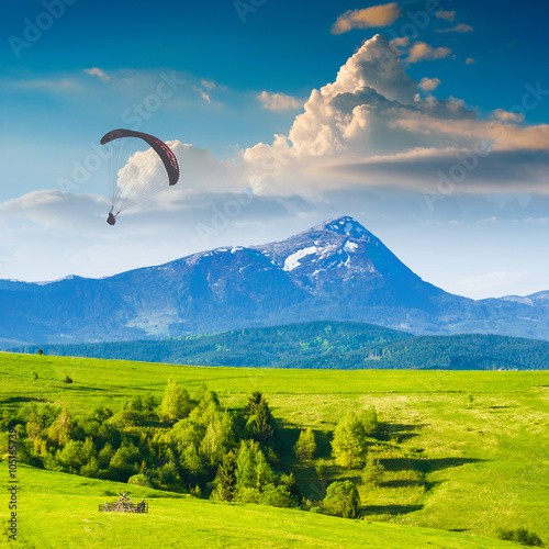 Flying over Carpathian spring mountain valley