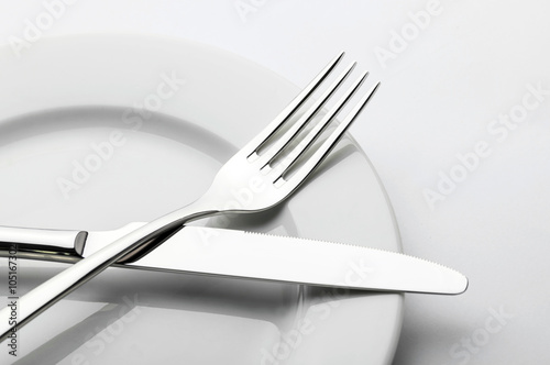 Plates and cutlery on a wooden table photo