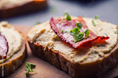 Spreads. Egg spread, grilled bacon, bread young basil leaves, Herb decoration. Ingredients: six eggs, spring onion, yeast, processed cheese, bacon, salt, pepper, various herbs decorations.