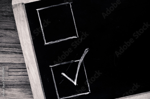 white chalk chek boxes on a slate blackboard photo