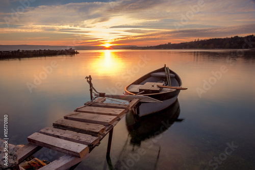 Beautiful light composition and mood of the boat at sunset