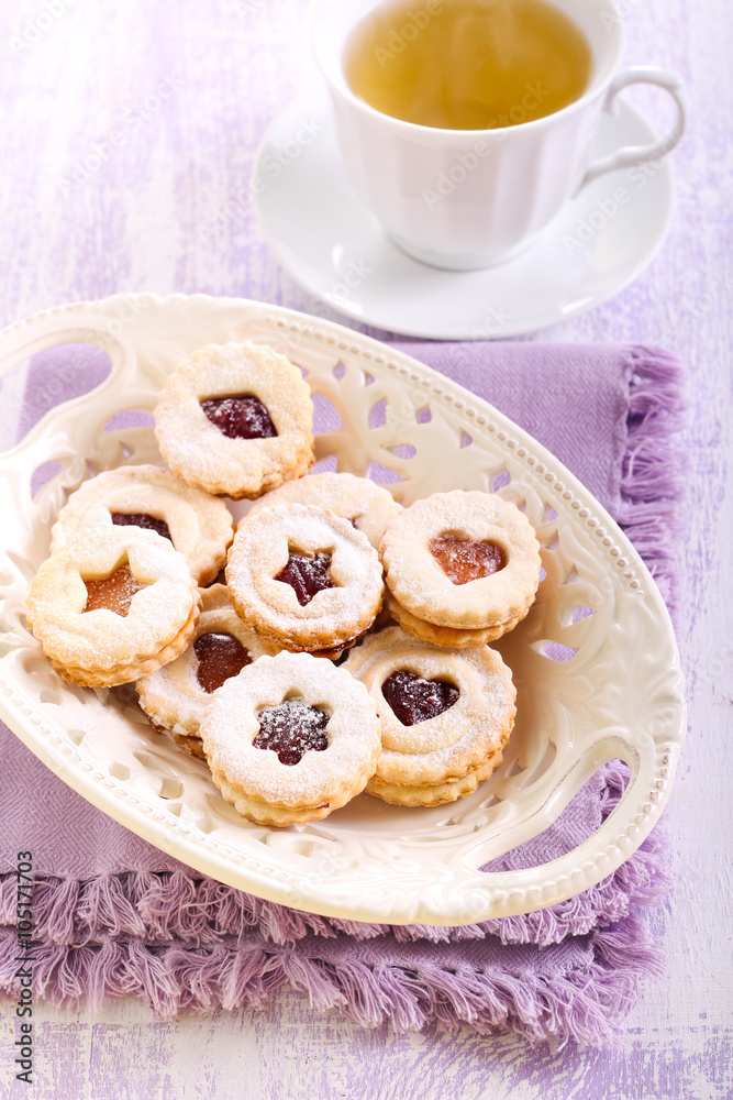Jam filling linzer cookies with icing sugar