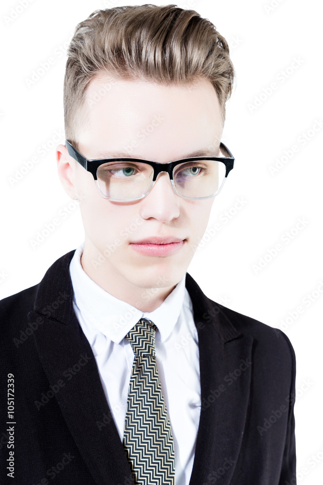 Close up picture of an elegant young fashion man wearing black suit on gray background

