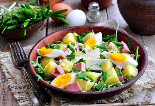 Salad of wild garlic with boiled potatoes, eggs, ham, parmesan and arugula