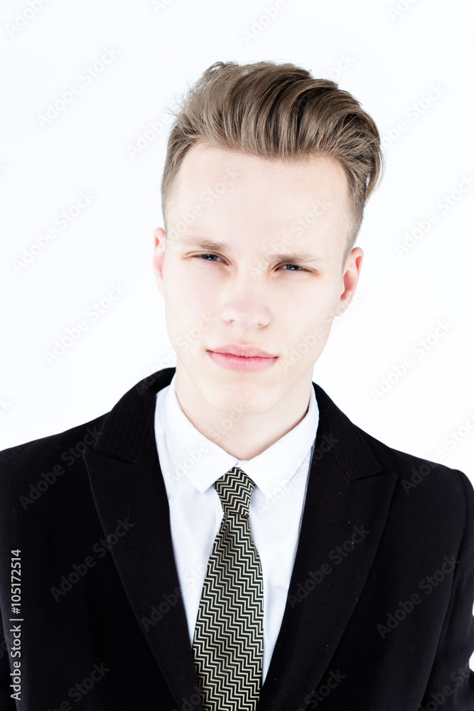Close up picture of an elegant young fashion man wearing black suit on gray background Close up picture of an elegant young fashion man wearing black suit on gray background