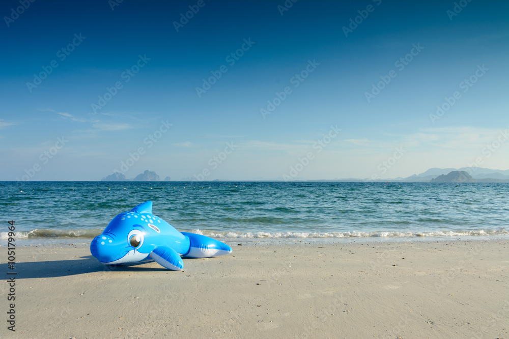 Children's beach toy in Dolphin shape on the beach