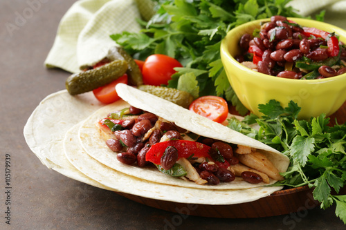 Quadro em tela Mexican food is tacos on wheat tortilla with chicken and beans