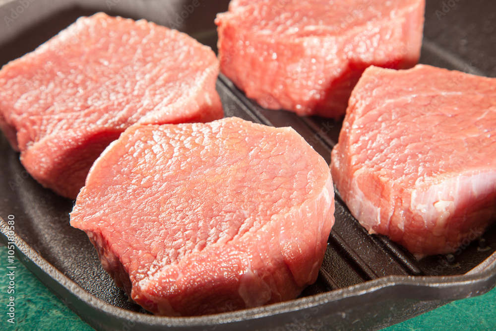 Above view of raw fresh marbled meat steaks, studio shot, closeup Above view of raw fresh marbled meat steaks, studio shot, closeup