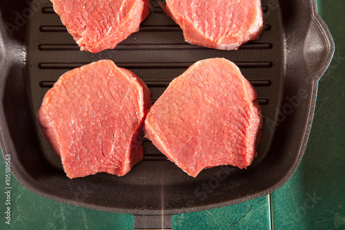 Above view of raw fresh marbled meat steaks, studio shot, closeup