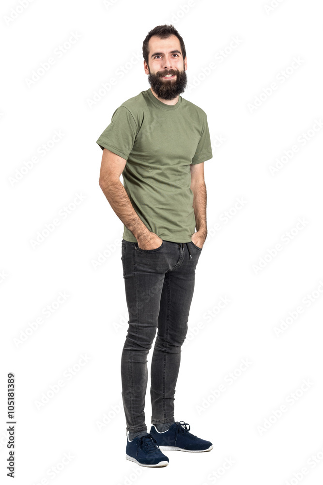 Happy smiling bearded hipster with hands in pockets. Full body length portrait isolated over white studio background. Happy smiling bearded hipster with hands in pockets. Full body length portrait isolated over white studio background.