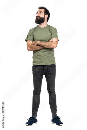 Proud confident bearded man with crossed arms looking up. Full body length portrait isolated over white studio background.