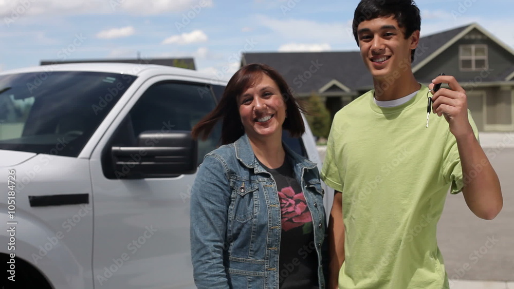 Mother and son, teen holds up keys to truck Mother and son, teen holds up keys to truck