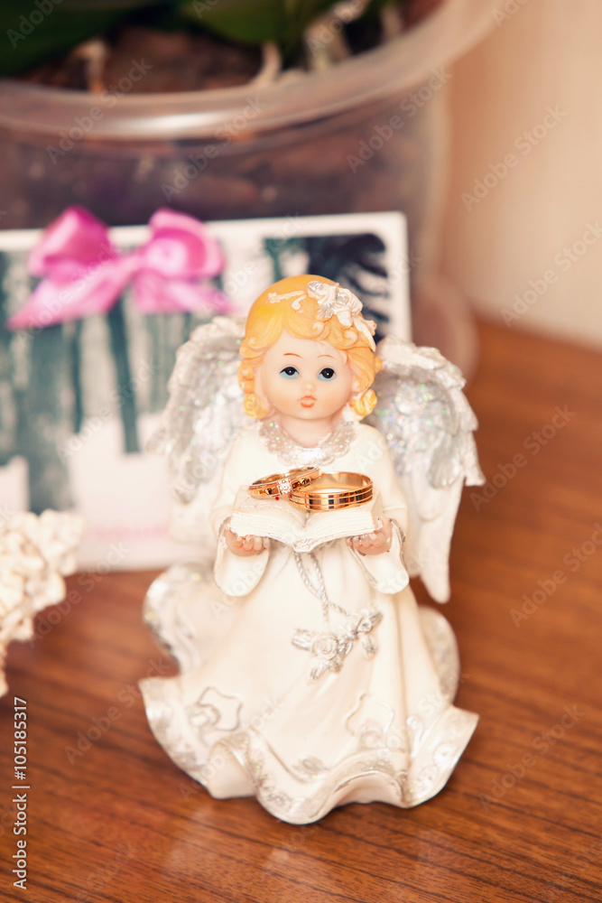 angel holding wedding rings angel holding wedding rings