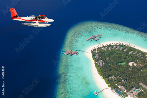 Fototapeta Naklejka Na Ścianę i Meble -  Sea plane flying above Maldives islands