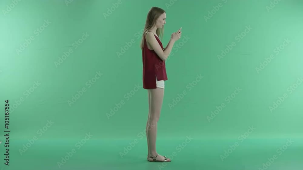 woman writes a message on the phone on a green screen woman writes a message on the phone on a green screen