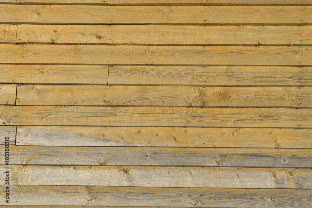 vertical picture of old horizontal planks with bright yellow pai vertical picture of old horizontal planks with bright yellow pai