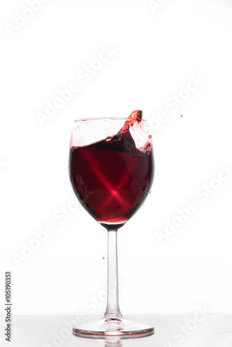 Red wine waving into a glass