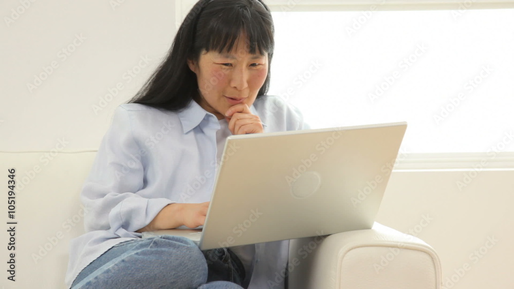 Mature Asian woman with laptop computer Mature Asian woman with laptop computer