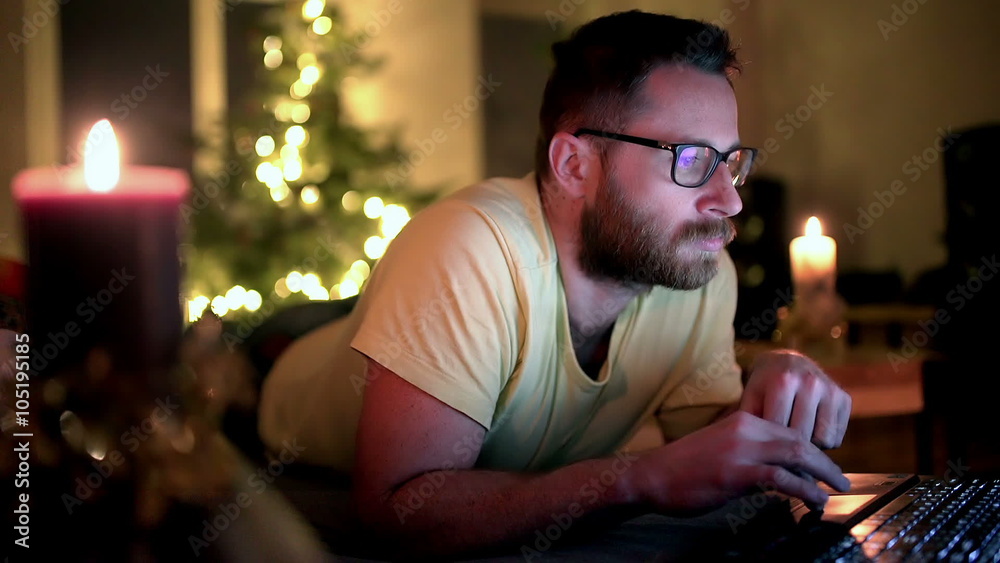 Man browsing internet on laptop and smiling to the camera at home
Man browsing internet on laptop and smiling to the camera at home