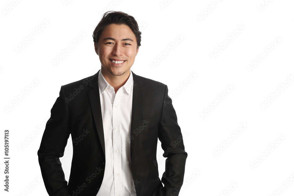 A young and professional businessman standing in front of a white background smiling looking at camera. A young and professional businessman standing in front of a white background smiling looking at camera.