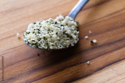 teaspoon with raw shelled hemp seeds