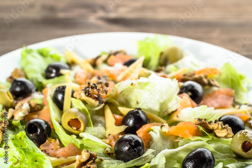 Mediterranean salad with salmon and olives, selective focus