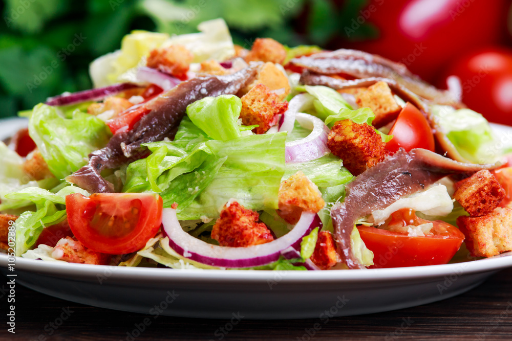 Fresh healthy Classic Caesar salad with anchovies. selected focus.