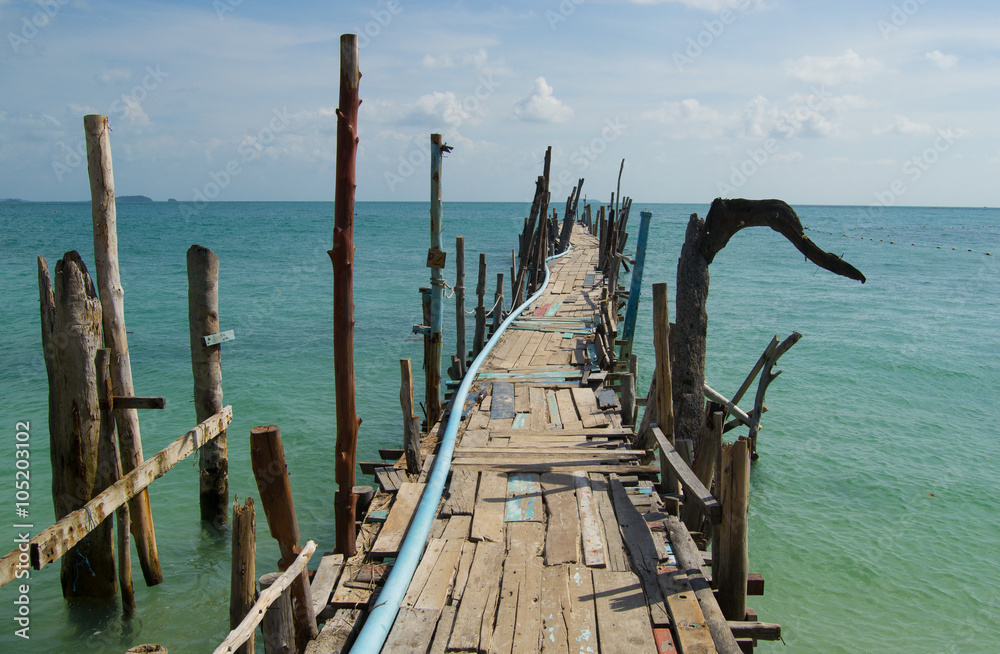 Long wooden pier on a tropical island in Thailand