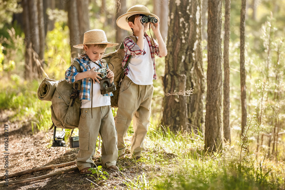 Fototapeta premium Boys on a forest road with backpacks