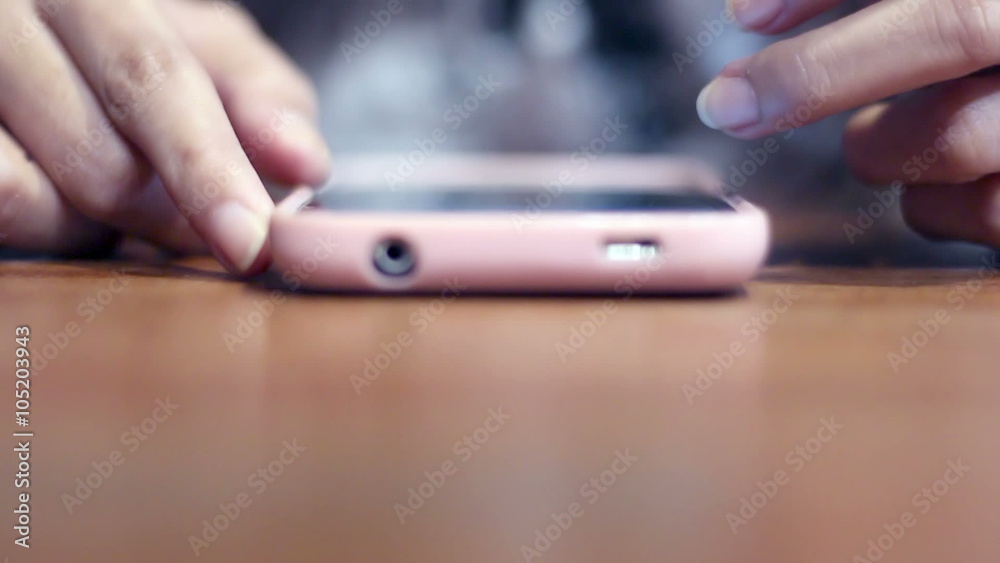 Soft focused girl's hands browsing smartphone