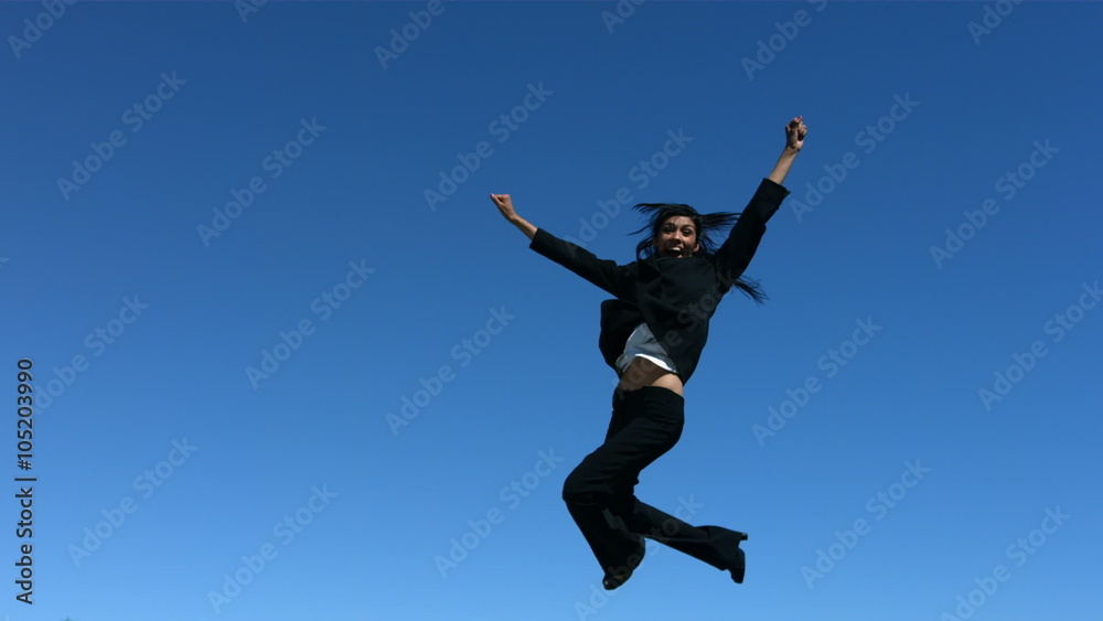 Businesswoman jumping in air celebrating, slow motion Businesswoman jumping in air celebrating, slow motion