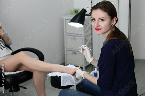 Pedicure master smiling in time of wirking photo