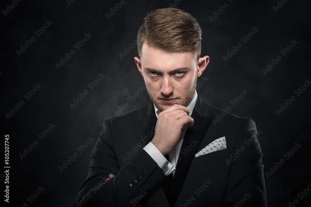 Elegant young man in suit looking frowning. Elegant young man in suit looking frowning.