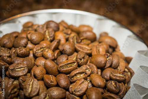 Coffee beans in white paper filter