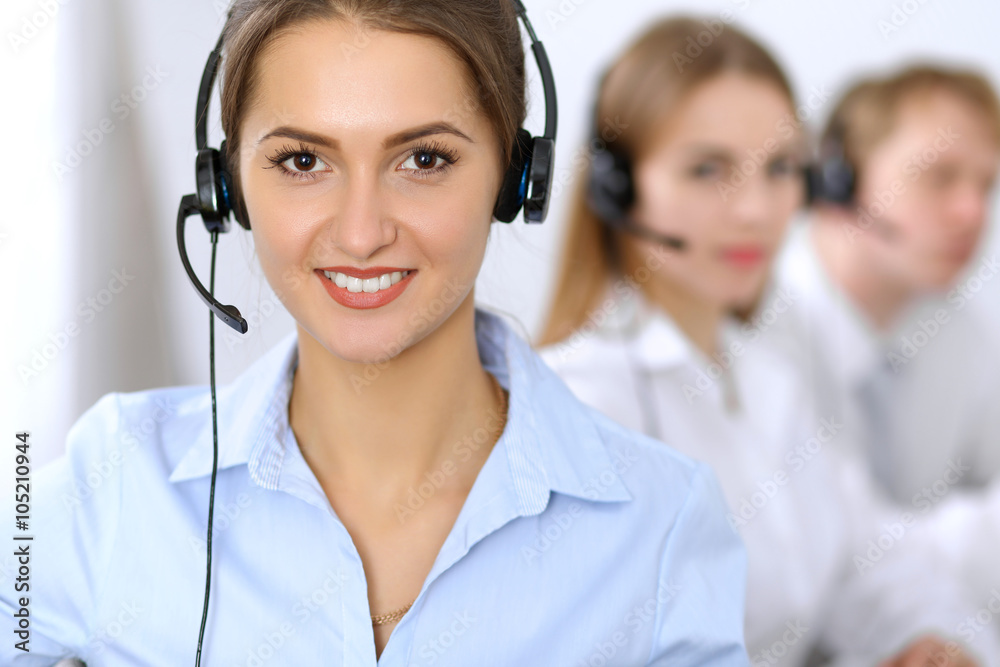 Call center. Focus on beautiful woman in headset Call center. Focus on beautiful woman in headset