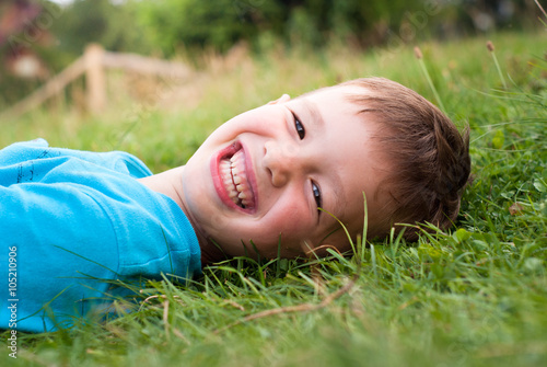 Smiling little boy in the grass