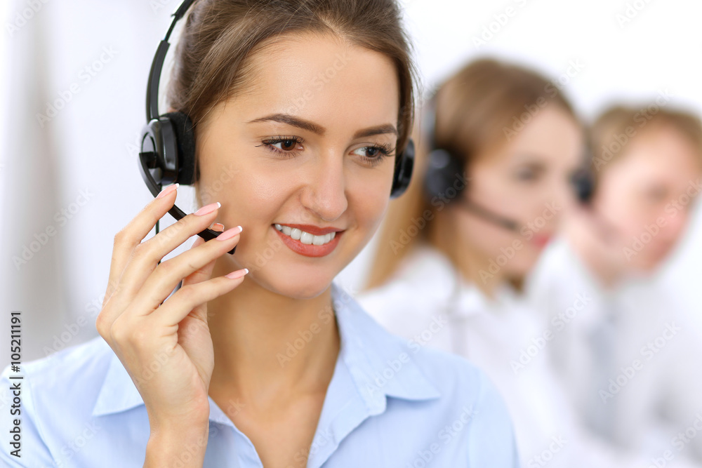 Call center. Focus on beautiful woman in headset Call center. Focus on beautiful woman in headset