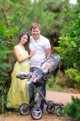 beautiful family with a baby in the park